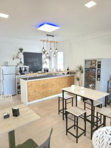 a restaurant with two tables and a kitchen with a counter at Sicily in Love - Rooms & Breakfast in Taormina
