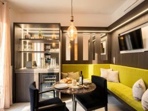 a living room with a yellow couch and a table at Terra | 2-Bedroom with Shared Kitchen & Balcony – Seafront Location in Polignano a Mare