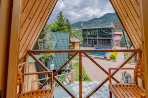 a view from the balcony of a house with two chairs at Vaio Resort in Keda in K'eda