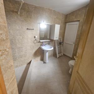 a bathroom with a sink and a toilet at Apartman Stepanović 2 in Prijevor