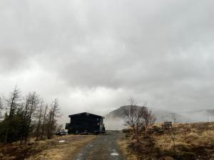 a barn on the side of a dirt road at Cozy Cabin Iceland in Reynivellir