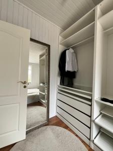 a dressing room with a mirror and a bedroom at Cozy Cabin Iceland in Reynivellir