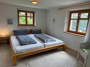 a bed in a room with two pillows on it at Haus am Rotkreuzweg mit Pool in Feldberg
