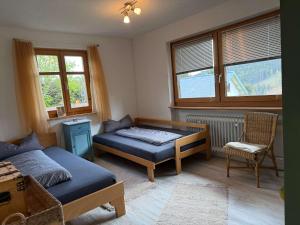 a bedroom with a bed and a table and a chair at Haus am Rotkreuzweg mit Pool in Feldberg