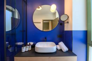 a bathroom with a white sink and a mirror at Luna Residence in Timişoara +36 photos
