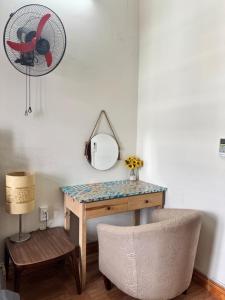 a dressing table with a mirror and a chair at Hava Hostel Lang Son in Lạng Sơn