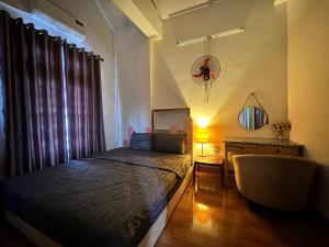 a bedroom with a bed and a desk and a lamp at Hava Hostel Lang Son in Lạng Sơn