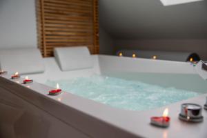 a bathroom with a tub with candles in it at Logement entier suite balnéo privée in Vierzon