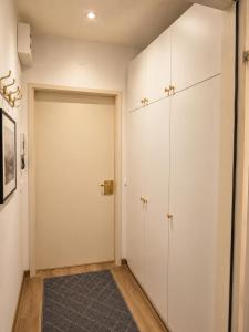 a closet with white cabinets and a door at Alpine Studio near Bad Ischl in Bad Ischl