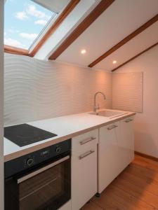 a kitchen with a sink and a stove at Villa JAM in Kaštela +4 photos