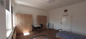 a room with a bed and a table and a door at Ferienwohnung in Georgenthal in Georgenthal