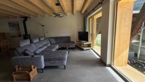 a living room with a couch and a tv at Ferienwohnung - schof in Tschierv