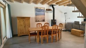 a dining room with a wooden table and chairs at Ferienwohnung - schof in Tschierv +17 photos