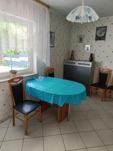 a kitchen with a table with a blue table cloth on it at Ferienwohnung mit Terrasse Ettringen in Ettringen