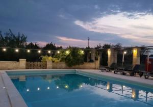 a swimming pool in a backyard at night at Tenuta del salento in Galatina