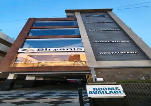 a building with a sign in front of it at Hotel Arunodaya Avenue in Srīkākulam