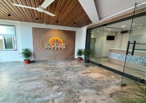a large lobby with a large painting on the wall at Hotel Arunodaya Avenue in Srīkākulam