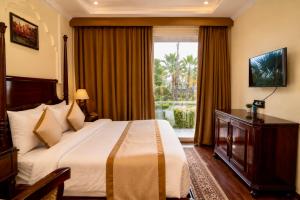 a hotel room with a bed and a window at Evaara By The Ganges A Ganga Access Resort & Jungle Safari in Haridwār +75 photos