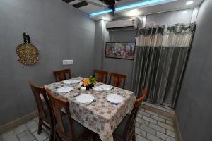 a dining room with a table with chairs and a tableablish at Ardas Villa Bikaner - Heritage Luxury Boutique Stay, With Free Pick Up and Drop in Bikaner