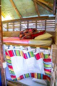 A bed or beds in a room at Flotsam and Jetsam Artist Beach Hostel