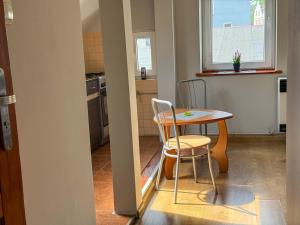 a small kitchen with a table and two chairs at 11 smart by LibertaRent in Wałbrzych