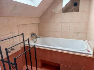 a bathroom with a white tub in a room at 11 smart by LibertaRent in Wałbrzych