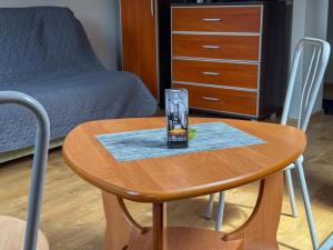 a wooden table with a glass on top of it at 11 smart by LibertaRent in Wałbrzych +17 photos