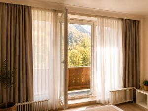 a room with a large window with a view at Alpine Studio near Bad Ischl#2 in Haiden