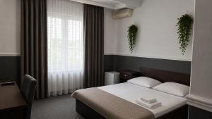 a hotel room with a bed and a window at Adria in Bieruń Nowy