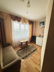 a living room with a couch and a table at готель Славутчанка in Slavuta