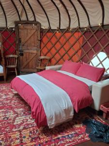 a bedroom with a bed in a yurt at Hillside Retreats in Machynlleth +7 photos