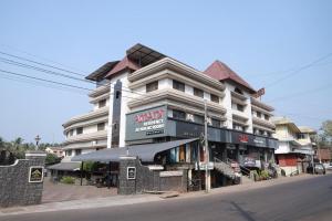 a large building on the corner of a street at Arma Residency Kannur in Kannur