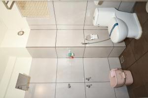 an overhead view of a bathroom with a toilet at Arma Residency Kannur in Kannur +31 photos