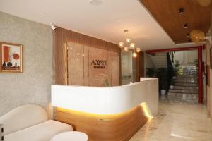 a lobby with a couch and a reception desk at Arma Residency Kannur in Kannur