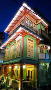 a colorful house with lights on the front of it at Mangaldas Ni Haveli II by The House of MG in Ahmedabad
