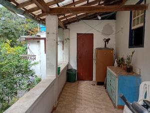 a hallway of a house with a red door at Casa da tranquilidade in Ouro Preto