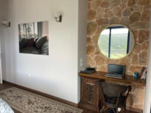 a room with a desk with a laptop on it at Villa Magiko in Poros