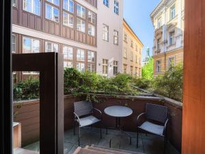 a balcony with a table and chairs in front of a building at EA Embassy Prague Hotel in Prague
