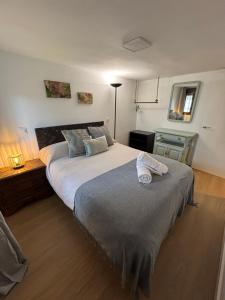 a bedroom with a large bed with a towel on it at Refugio 1900 in San Cristóbal de Segovia