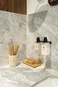 a bathroom with a counter with two bottles of soap at Pana Unique Kolsay in Kurmenty +102 photos