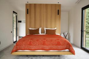 a bedroom with a large bed with a wooden headboard at Pana Unique Kolsay in Kurmenty