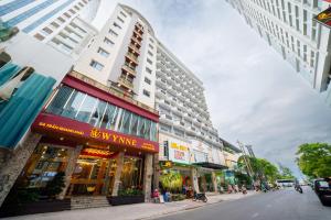 a city street with tall buildings and a building at WYNNE Hotel Nha Trang in Nha Trang