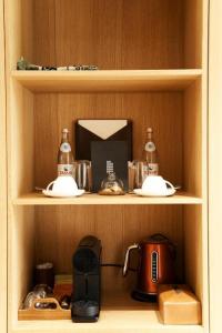 a wooden shelf with a coffee maker and a tea kettle at Pana Unique Kolsay in Kurmenty