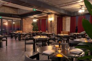 a restaurant with tables and chairs in a room at The Wine Station in Tsinandali