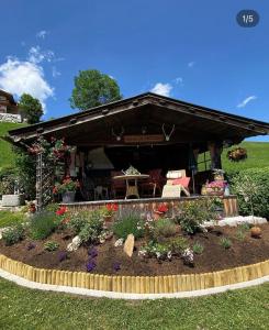 a garden in front of a building with a patio at Landhaus Aigner in Mittersill