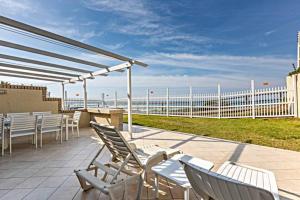 a patio with chairs and tables and a white fence at Club 10 Management in Ballito