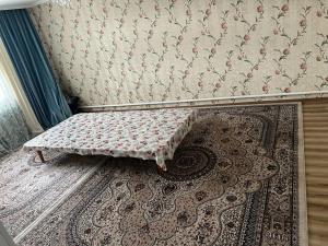 a small bench sitting on the floor in a room at Aimir in Akchiy