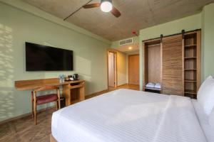 a bedroom with a bed and a desk and a television at The Wine Station in Tsinandali