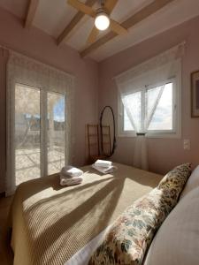 a bedroom with a bed with two towels on it at Amanda's House in Poros
