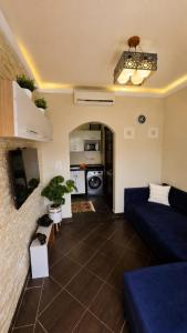 a living room with a blue couch and a kitchen at Porto Matrouh unique Chalet in Marsa Matruh